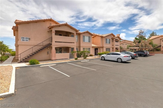 8450 Alta Dr Unit 136, Las Vegas, NV 89145 - view of building exterior featuring stairway and uncovered parking