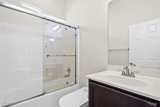 bathroom with bath / shower combo with glass door, toilet, and vanity