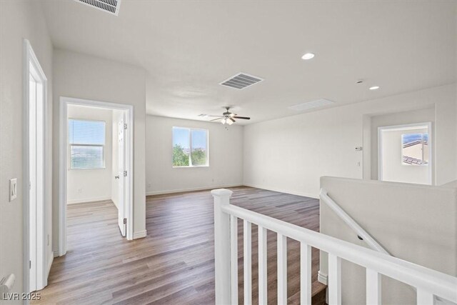 hall with recessed lighting, visible vents, baseboards, and light wood-type flooring
