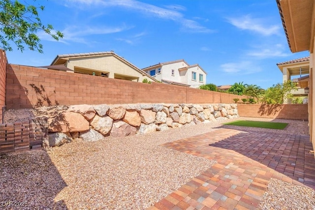 view of yard featuring a patio area and a fenced backyard