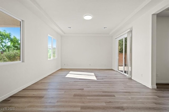 empty room with wood finished floors and plenty of natural light