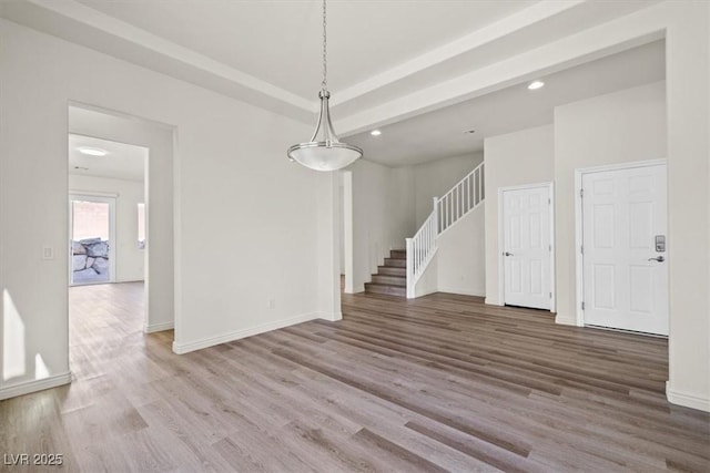 interior space with recessed lighting, stairs, wood finished floors, and baseboards