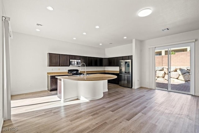 kitchen featuring visible vents, baseboards, stainless steel appliances, and light countertops