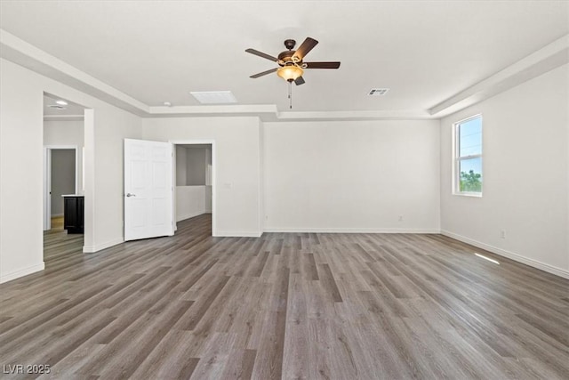 unfurnished living room featuring visible vents, ceiling fan, wood finished floors, and baseboards