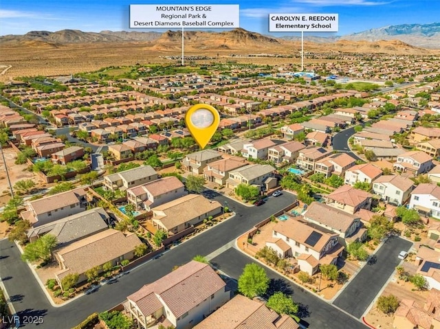 aerial view featuring a mountain view and a residential view