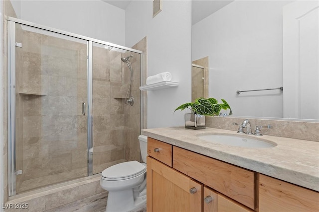 bathroom with toilet, visible vents, and a shower stall