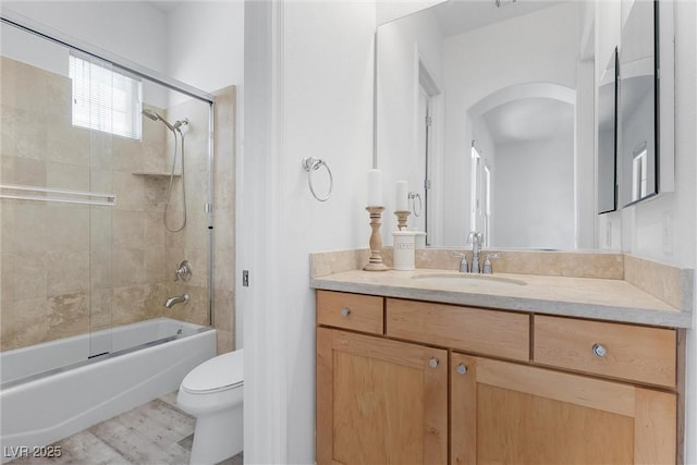 full bathroom featuring toilet, enclosed tub / shower combo, and vanity
