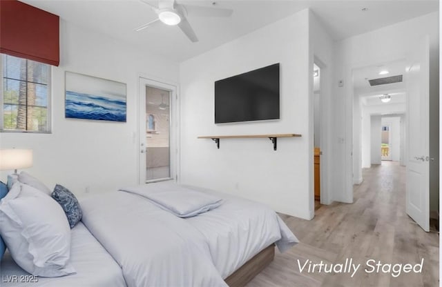 bedroom featuring visible vents, a ceiling fan, and light wood-style flooring