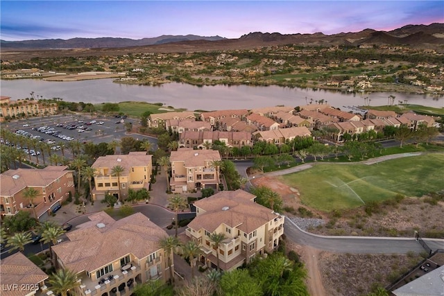 drone / aerial view featuring a residential view and a water and mountain view