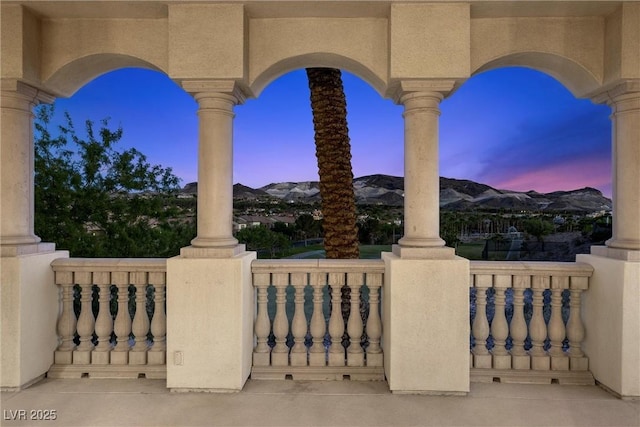 view of patio / terrace with a mountain view and a balcony