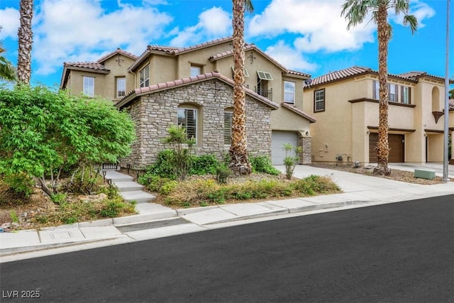 3217 Palladio Ave, North Las Vegas, NV 89031 - mediterranean / spanish home featuring stone siding, stucco siding, driveway, a tiled roof, and an attached garage