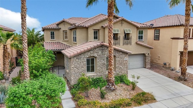 3217 Palladio Ave, North Las Vegas, NV 89031 - mediterranean / spanish-style home featuring stone siding, a tile roof, an attached garage, and stucco siding