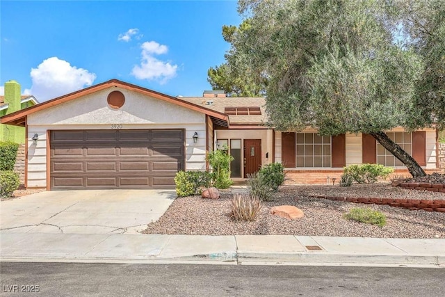 3920 Autumn St, Las Vegas, NV 89120 - ranch-style home with a garage, concrete driveway, and brick siding