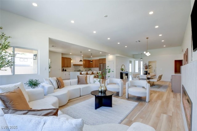 living area featuring light wood finished floors, recessed lighting, and a wealth of natural light