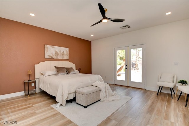 bedroom with light wood-style floors, access to exterior, visible vents, an accent wall, and french doors