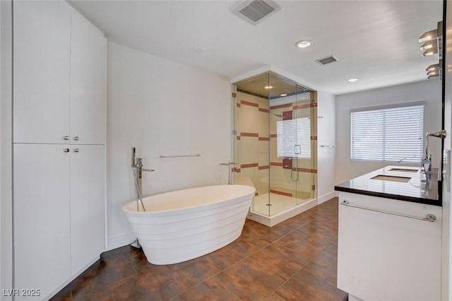 7575 Coley Ave, Las Vegas, NV 89117 - full bath with a stall shower, a freestanding tub, vanity, and recessed lighting