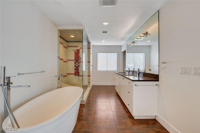 7575 Coley Ave, Las Vegas, NV 89117 - bathroom featuring a freestanding bath, a stall shower, vanity, tile patterned flooring, and recessed lighting
