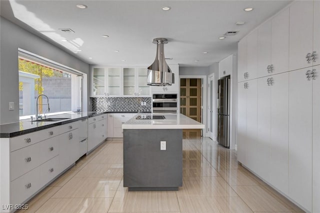 7575 Coley Ave, Las Vegas, NV 89117 - kitchen featuring freestanding refrigerator, white cabinetry, backsplash, and recessed lighting