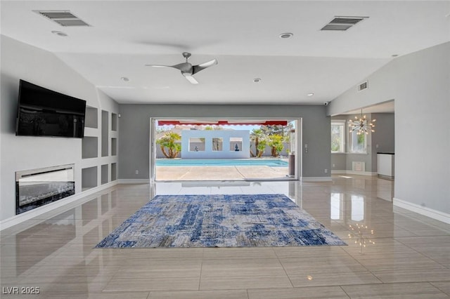 7575 Coley Ave, Las Vegas, NV 89117 - tiled living room with vaulted ceiling, a chandelier, a glass covered fireplace, a ceiling fan, and built in features