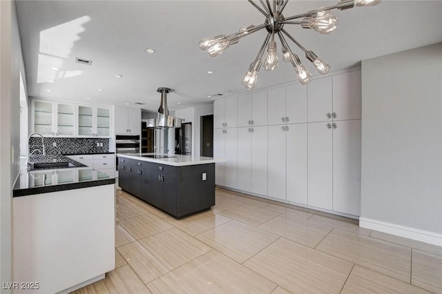 7575 Coley Ave, Las Vegas, NV 89117 - kitchen with a chandelier, white cabinets, a center island, pendant lighting, and black electric stovetop