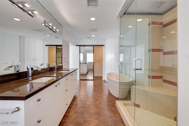 7575 Coley Ave, Las Vegas, NV 89117 - full bath featuring a freestanding tub, vanity, a shower stall, tile patterned flooring, and recessed lighting