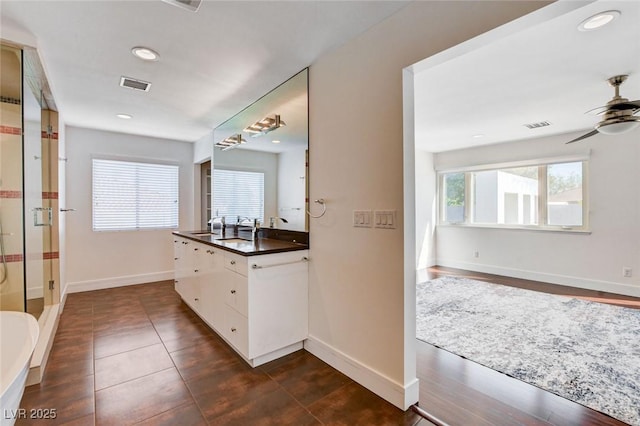 7575 Coley Ave, Las Vegas, NV 89117 - bathroom with vanity, a ceiling fan, a shower stall, and recessed lighting