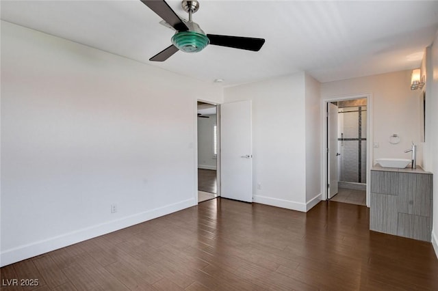 7575 Coley Ave, Las Vegas, NV 89117 - unfurnished bedroom featuring wood finished floors, connected bathroom, and ceiling fan