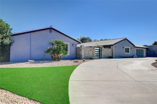 7575 Coley Ave, Las Vegas, NV 89117 - view of front of property featuring driveway, a garage, stucco siding, and a gate