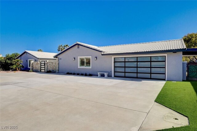 7575 Coley Ave, Las Vegas, NV 89117 - ranch-style house with an attached garage, concrete driveway, stucco siding, and a tile roof