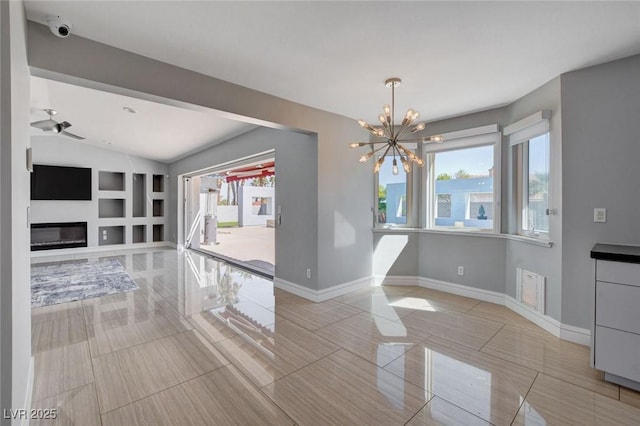7575 Coley Ave, Las Vegas, NV 89117 - unfurnished dining area featuring a chandelier, healthy amount of natural light, a glass covered fireplace, lofted ceiling, and ceiling fan