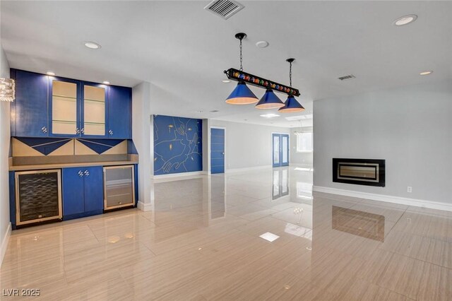 7575 Coley Ave, Las Vegas, NV 89117 - unfurnished living room with beverage cooler, light tile patterned flooring, a glass covered fireplace, and recessed lighting