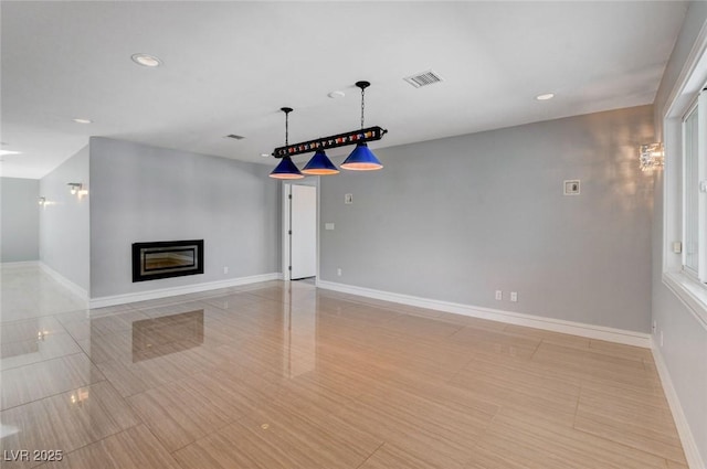 7575 Coley Ave, Las Vegas, NV 89117 - unfurnished living room with recessed lighting and a glass covered fireplace