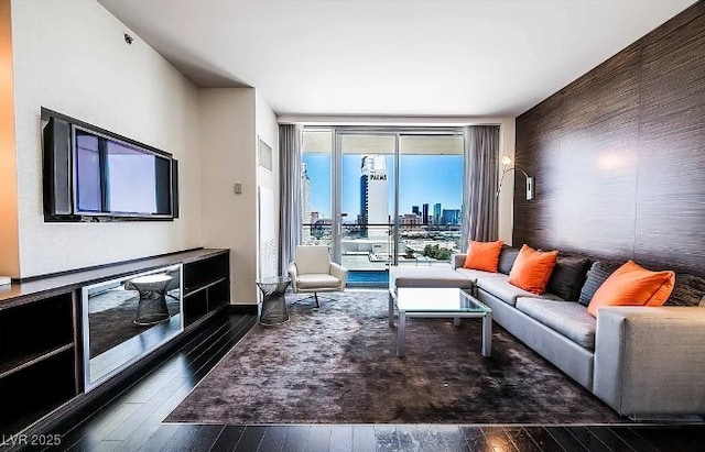 4381 W Flamingo Rd Unit 1212, Las Vegas, NV 89103 - living area with floor to ceiling windows, a city view, and dark wood-type flooring