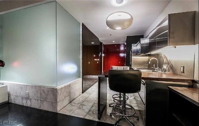 4381 W Flamingo Rd Unit 1212, Las Vegas, NV 89103 - kitchen featuring a wainscoted wall and a sink