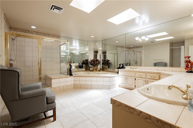 2255 S Buffalo Dr, Las Vegas, NV 89117 - full bathroom featuring a skylight, vanity, tile patterned floors, a bath, and a shower stall