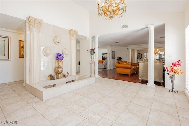 2255 S Buffalo Dr, Las Vegas, NV 89117 - foyer entrance featuring ornate columns, a chandelier, ornamental molding, light tile patterned floors, and baseboards