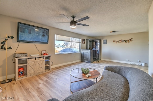 2129 N Michael Way, Las Vegas, NV 89108 - living room featuring ceiling fan, light wood-style flooring, and a textured ceiling