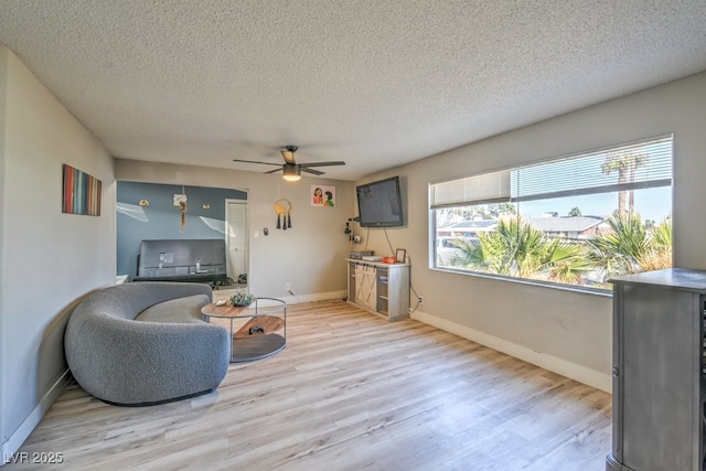 2129 N Michael Way, Las Vegas, NV 89108 - living area featuring ceiling fan, a textured ceiling, and light wood-style flooring