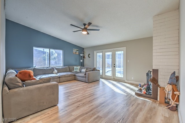 2129 N Michael Way, Las Vegas, NV 89108 - living area with lofted ceiling, a ceiling fan, light wood-style floors, a textured ceiling, and french doors