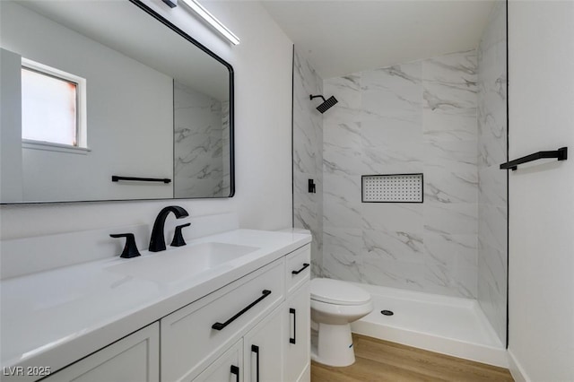 2671 Diamante Cir, Las Vegas, NV 89121 - full bathroom featuring toilet, a marble finish shower, wood finished floors, and vanity