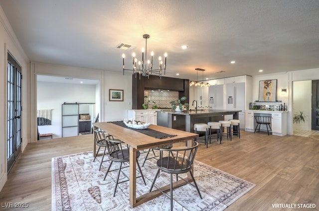 dining room with recessed lighting, visible vents, a chandelier, and light wood-type flooring