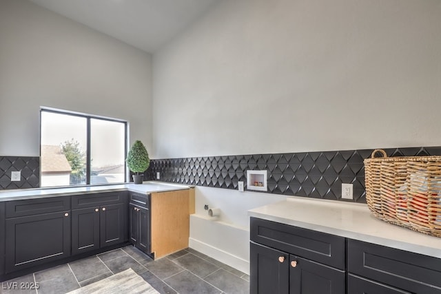 bathroom with tile patterned floors, a bath, and backsplash