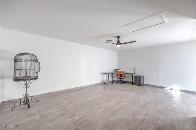 office featuring attic access, a ceiling fan, visible vents, baseboards, and wood finished floors