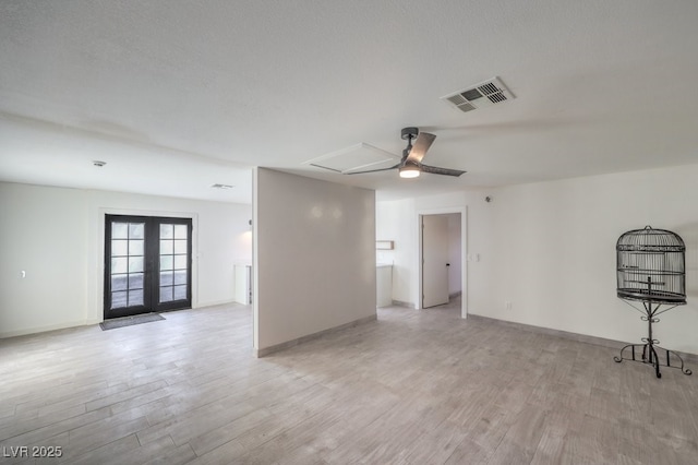 unfurnished living room featuring visible vents, ceiling fan, light wood-style flooring, and baseboards