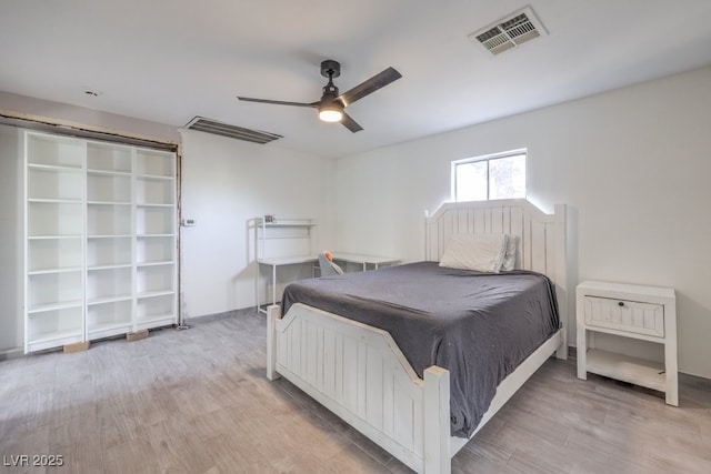 bedroom featuring a ceiling fan, visible vents, and light wood-style floors