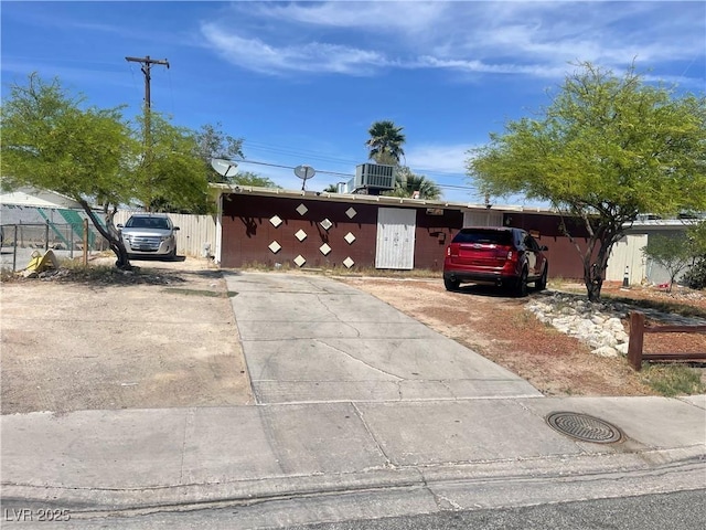 ranch-style house with central AC and fence
