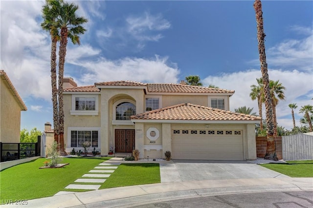 mediterranean / spanish house with stucco siding, a tiled roof, fence, a garage, and driveway