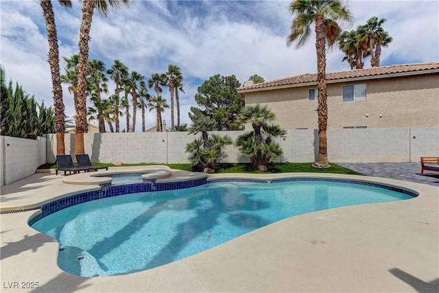 view of pool featuring a patio area, a pool with connected hot tub, and a fenced backyard
