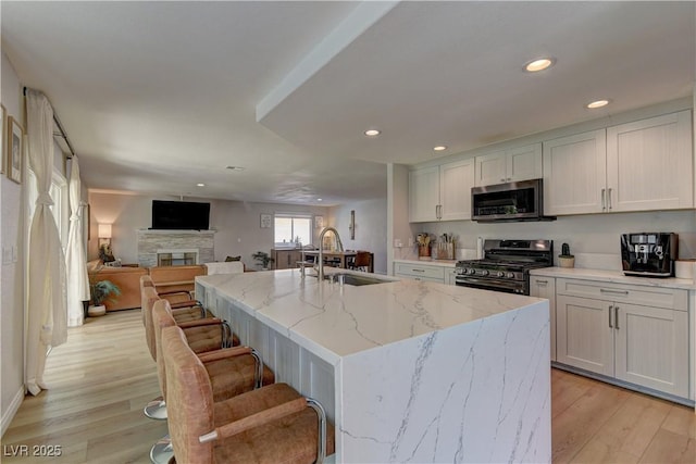 kitchen with recessed lighting, a sink, light wood-style flooring, and stainless steel appliances