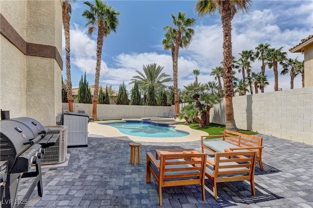 view of swimming pool with an in ground hot tub, a patio, a fenced in pool, and a fenced backyard